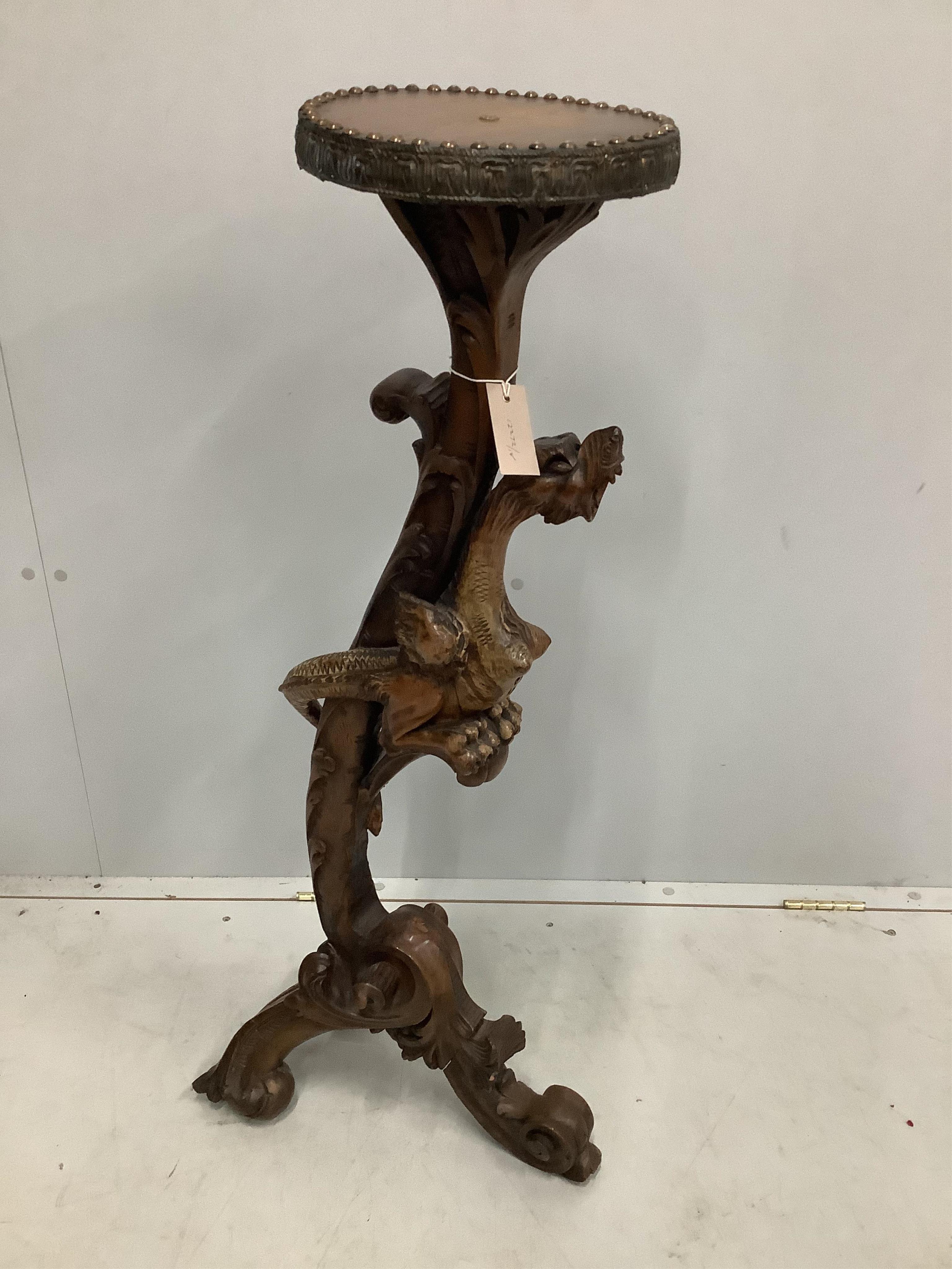 An Italian pine and carved walnut torchere with dragon column, height 100cm. Condition - fair